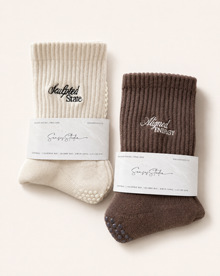 Two pairs of socks, one beige and one brown, with labels on a white background.